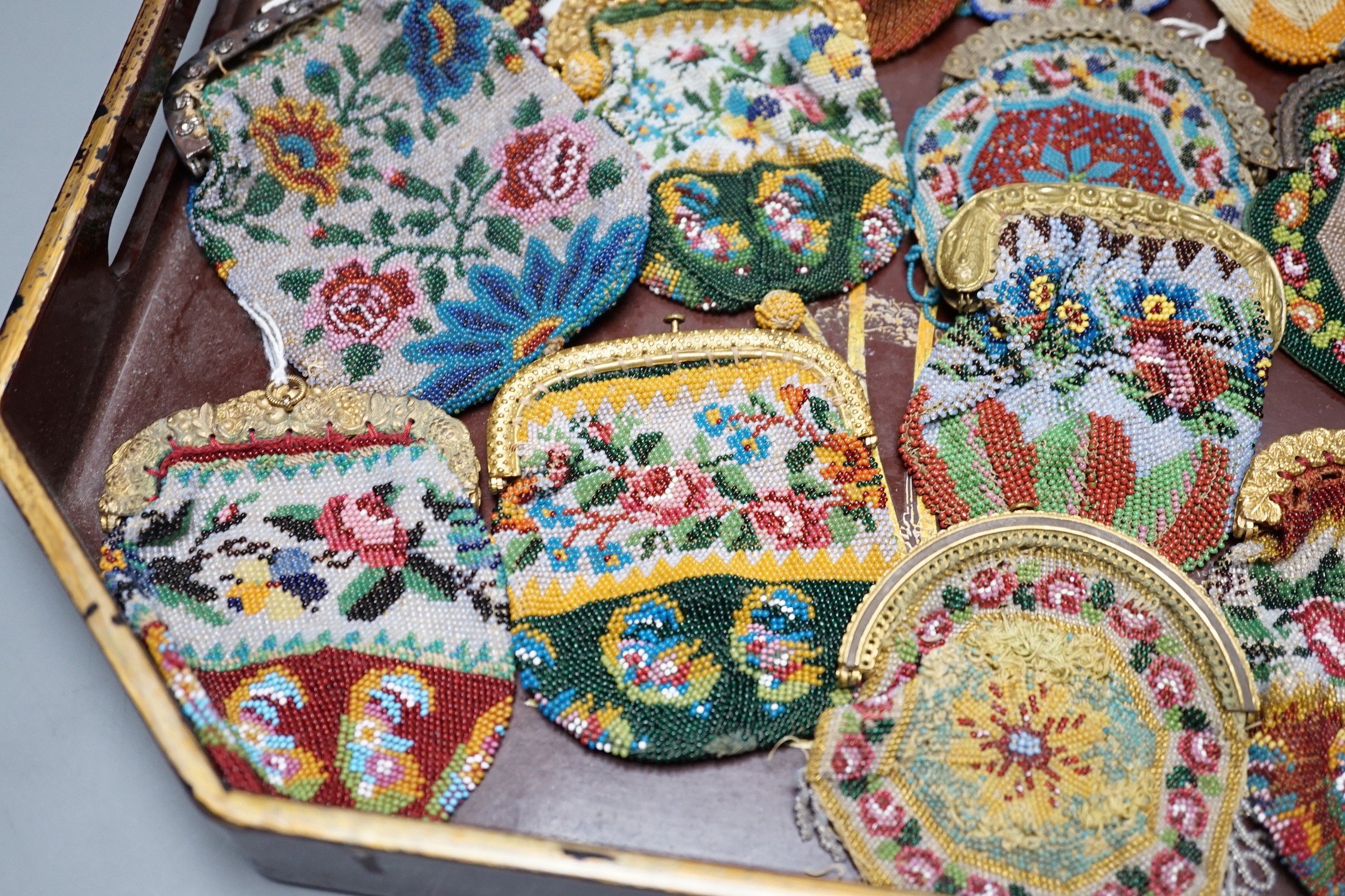 Twenty mid-19th century Berlin beadwork purses with gilt-metal frames, largest 10cm